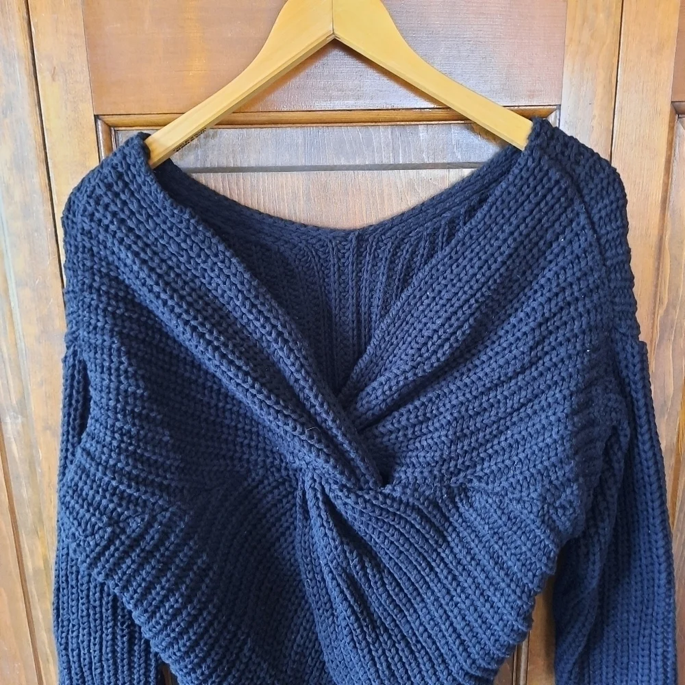 Black chunky ribbed knit crewneck sweater with back v-neck twist knot